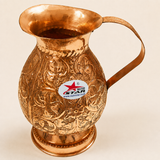 Embossed copper serving jug with floral design and comfortable handle