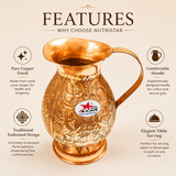 Embossed copper serving jug with floral design and comfortable handle