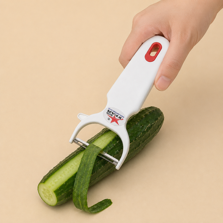 Nutristar white Y-shaped vegetable peeler with stainless steel blade and red hanging loop